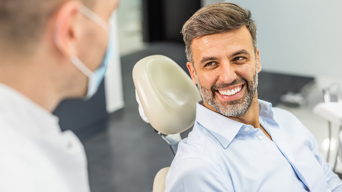 Man in dress shirt at the dentist